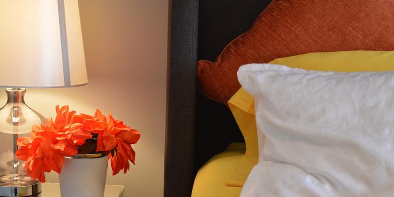 Bedroom with lamp and nightstand. Interstate Pest Management serving Portland OR & Vancouver WA talks about bed bugs.