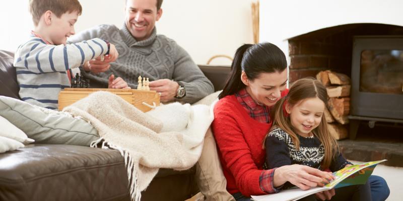 Family looking happy and comfy in their home. Interstate Pest Management serving Portland OR & Vancouver WA talks about 5 Ways to Prepare Your Home for the Winter.
