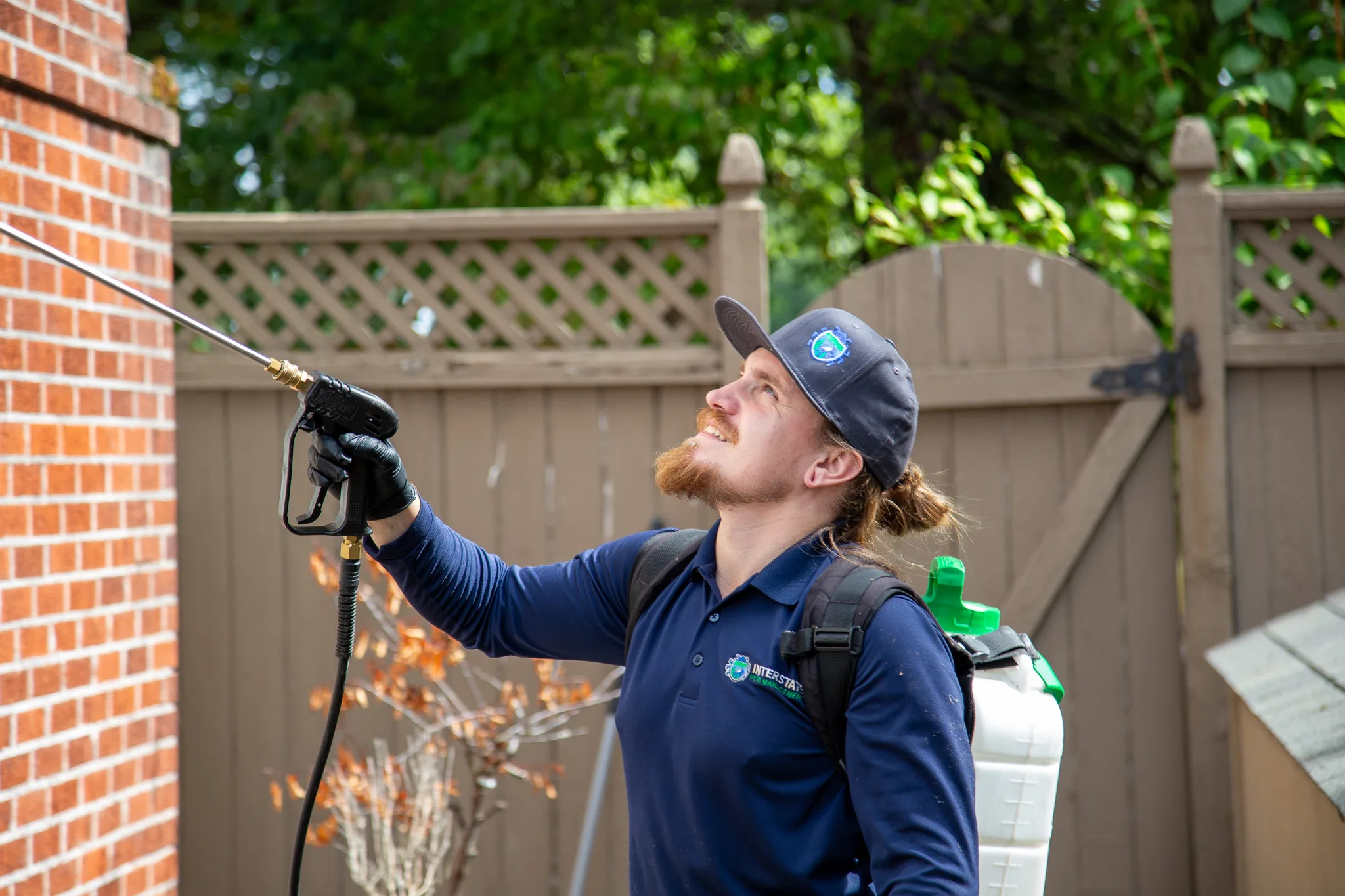 Interstate Pest Management technician Jarrod performing spider control treatment at a home in Longview, WA.