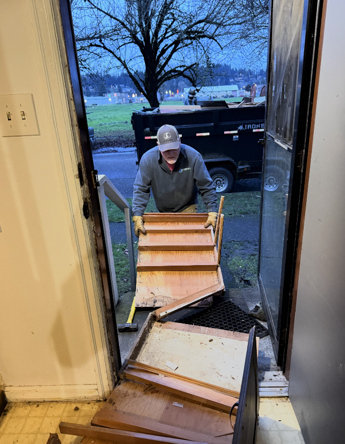 Brad Thorstenson removing debris from the demolition of the old spaces in the home. 