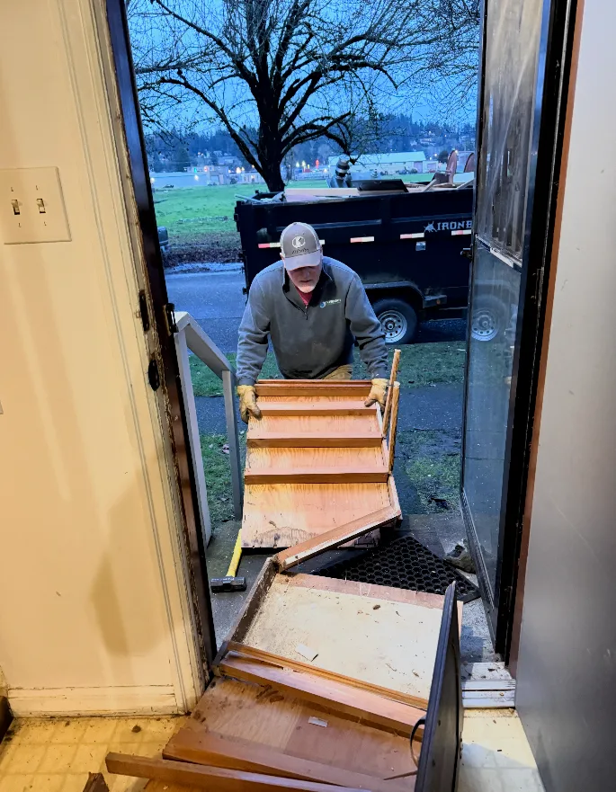 Brad Thorstenson removing debris from the demolition of the old spaces in the home. 
